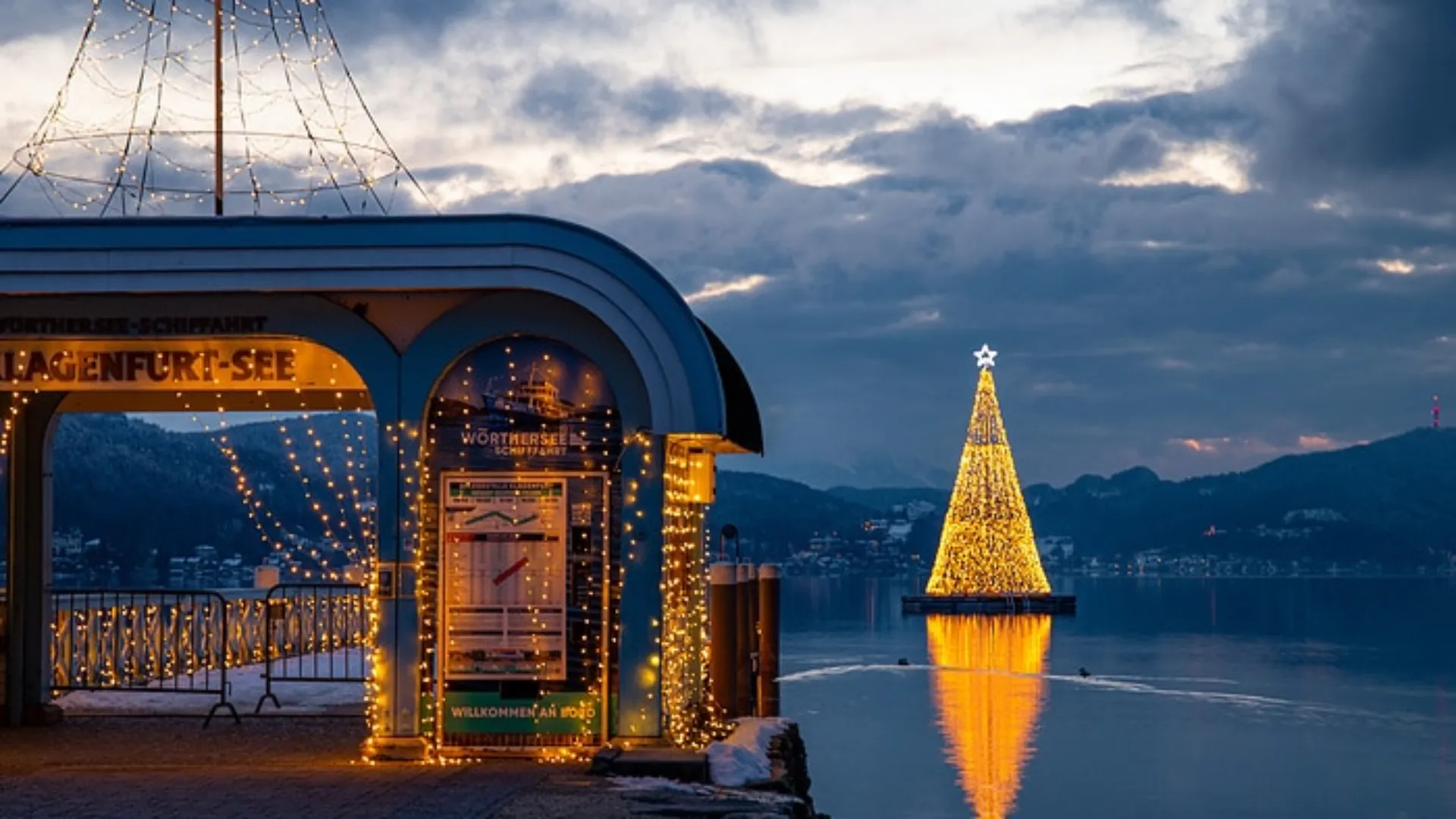Beleuchteter Eingang und Weihnachtsbaum im Wasser